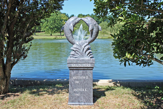 Cremation Pedestals placed in Serenity Garden with two dolphins creating a circle.