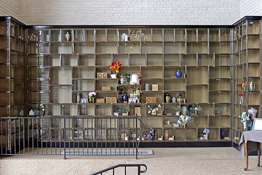 Glass front cremation niches for displaying cremation urns in Mausoleum Chapel.
